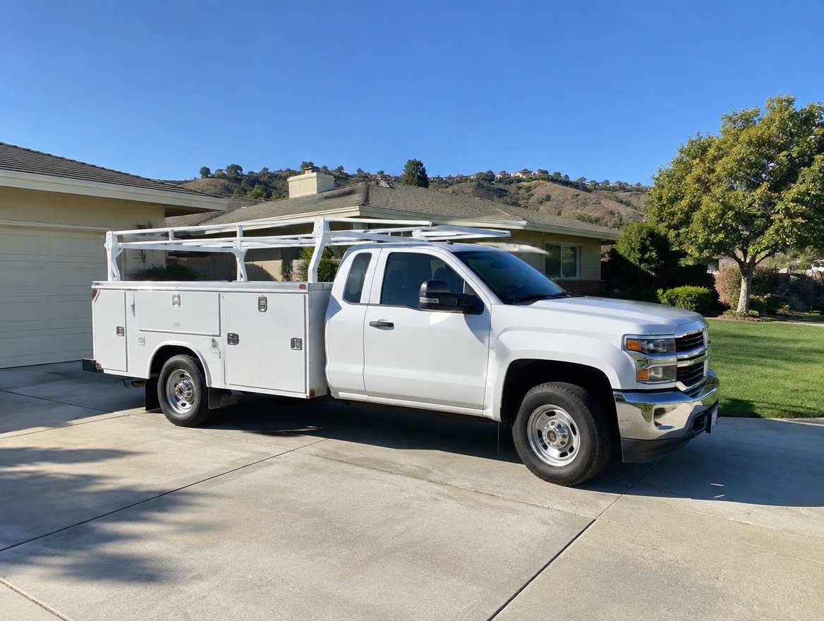 An unmarked plumbing service van parked at a home in Coyote Hills, California