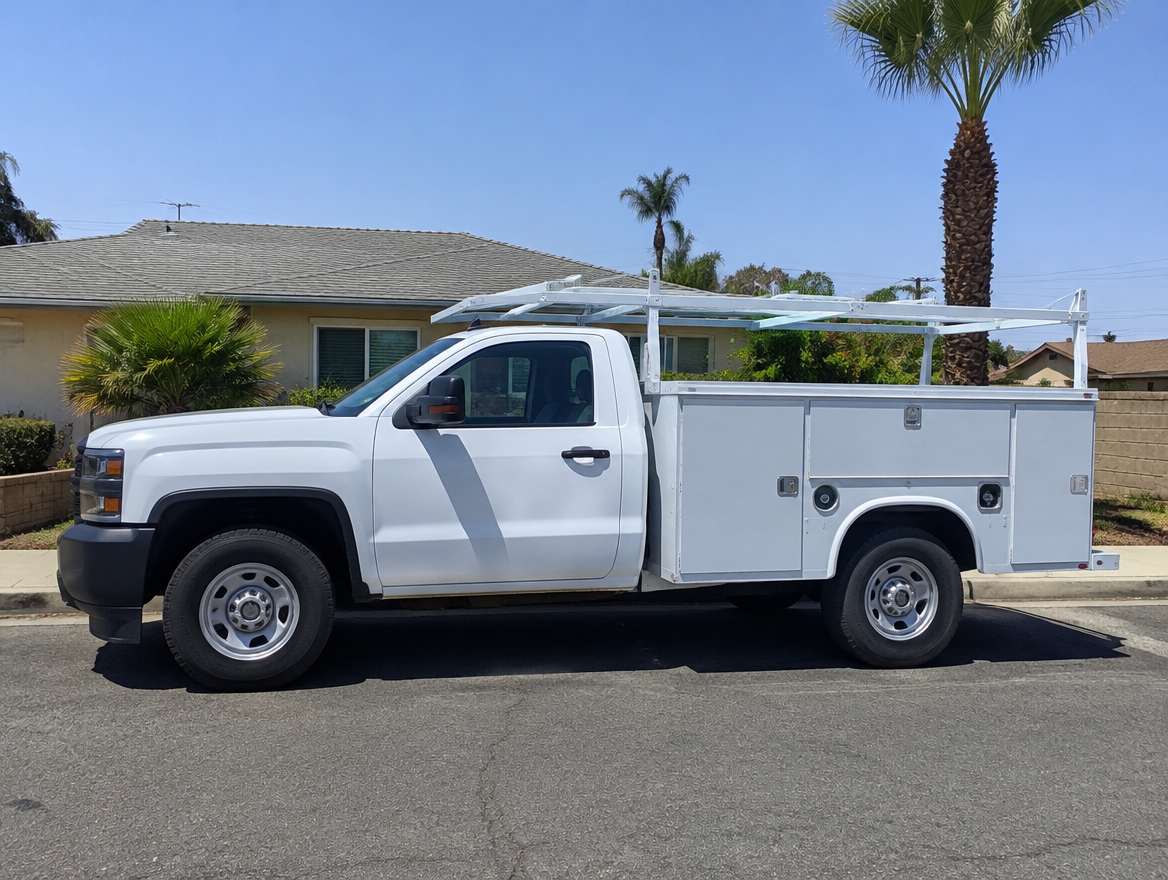 An unmarked plumbing service van parked at a home in Fullerton, California