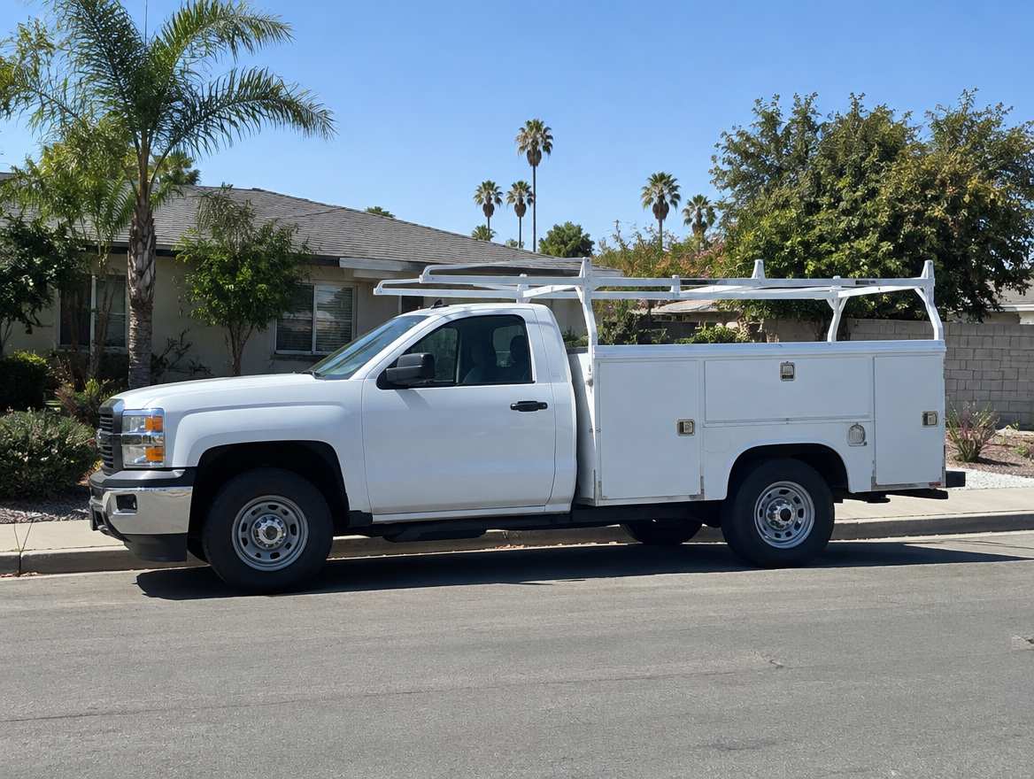 An unmarked plumbing service van parked at a home in Fullerton, California