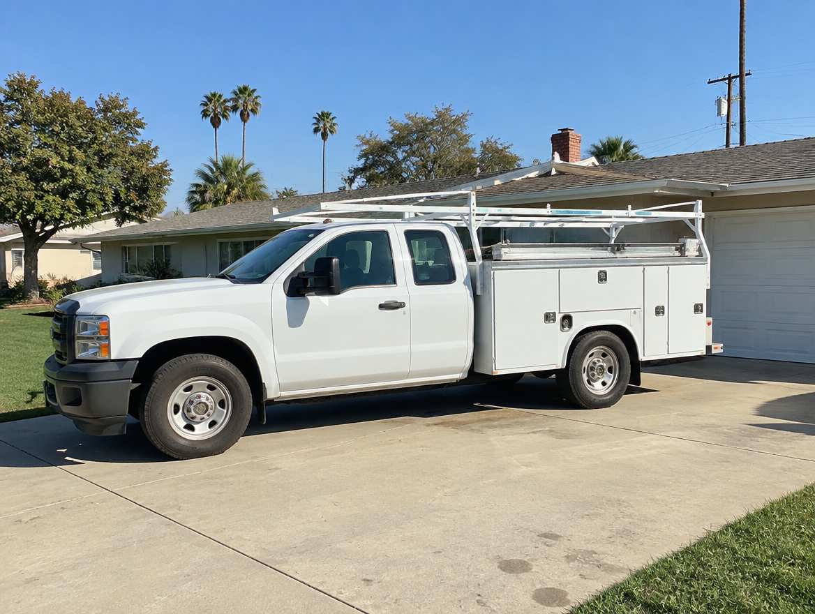 An unmarked plumbing service van parked at a home in Fullerton, California