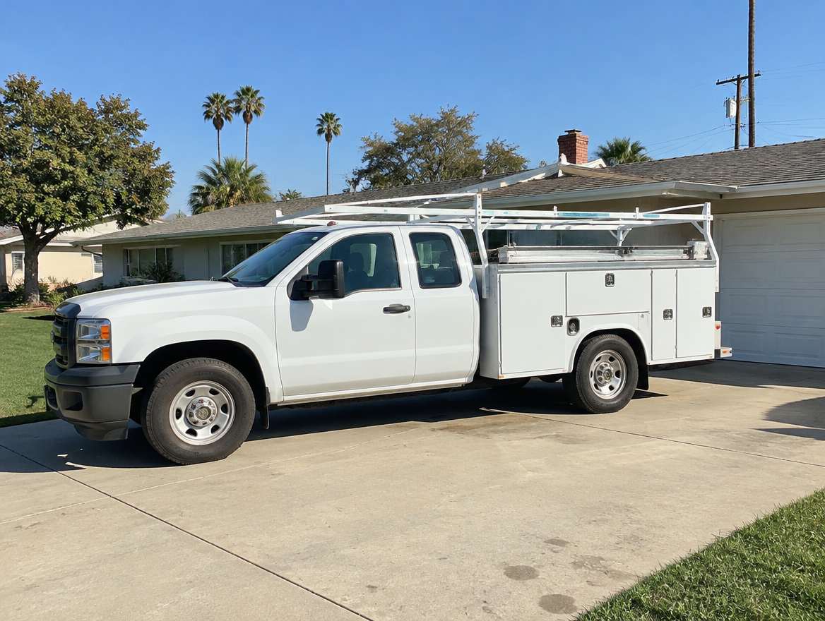 An unmarked plumbing service van parked at a home in Fullerton, California