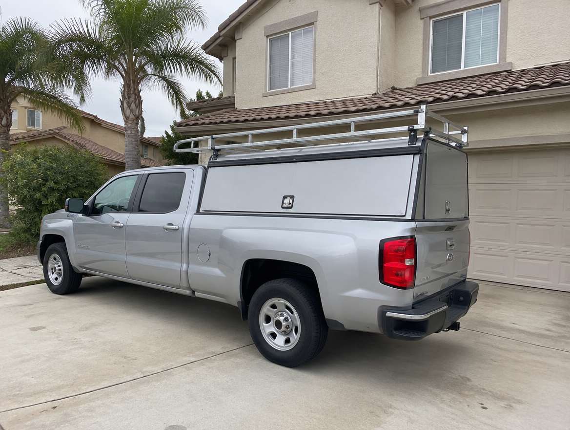 An unmarked plumbing service van parked at a home in Orange, California