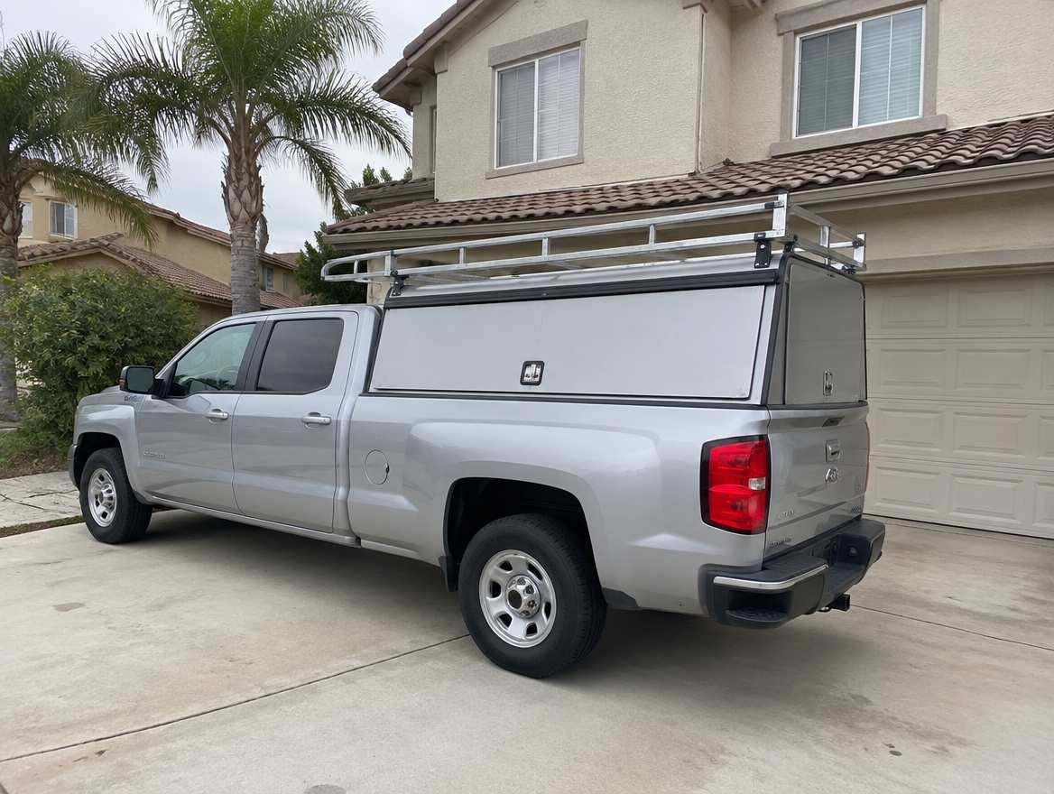 An unmarked plumbing service van parked at a home in Orange, California